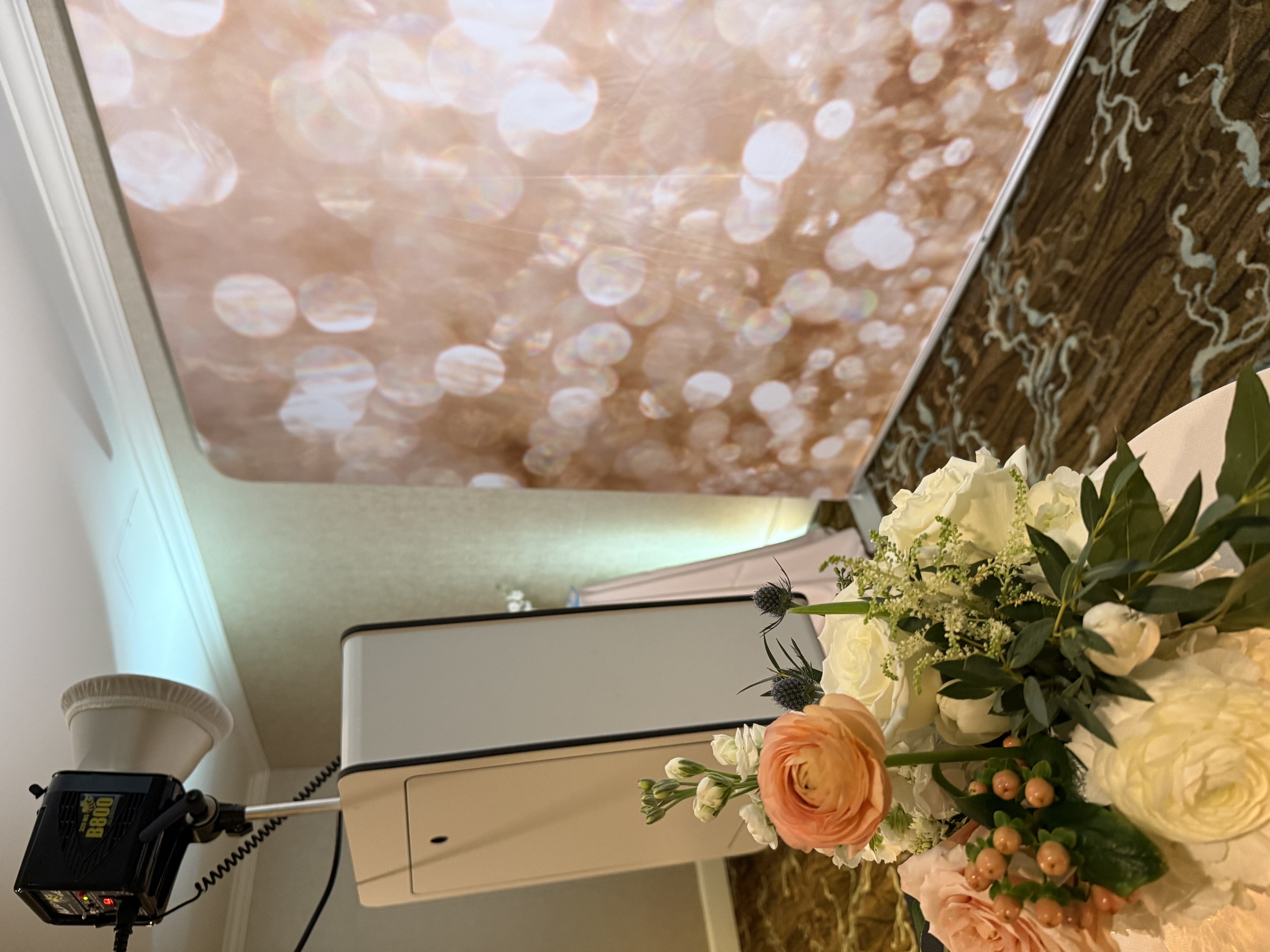 Professional wedding photo booth attendant helping guests at Jacksonville FL reception