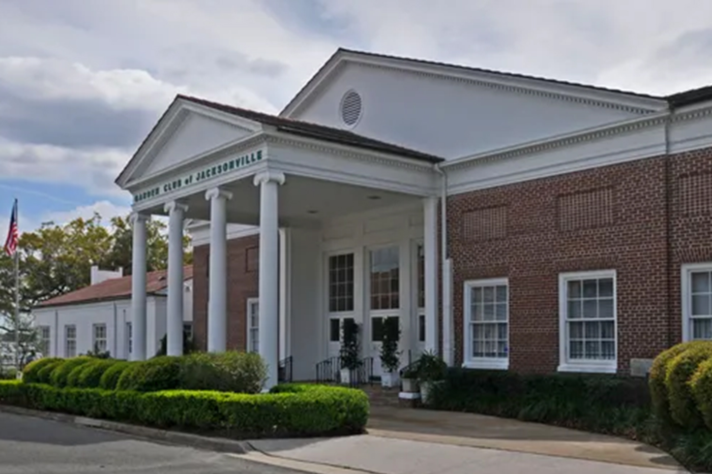 Garden Club of Jacksonville wedding venue in Riverside FL, illuminated brick building with white columns and pediment at night, Garden Club of Jacksonville signage