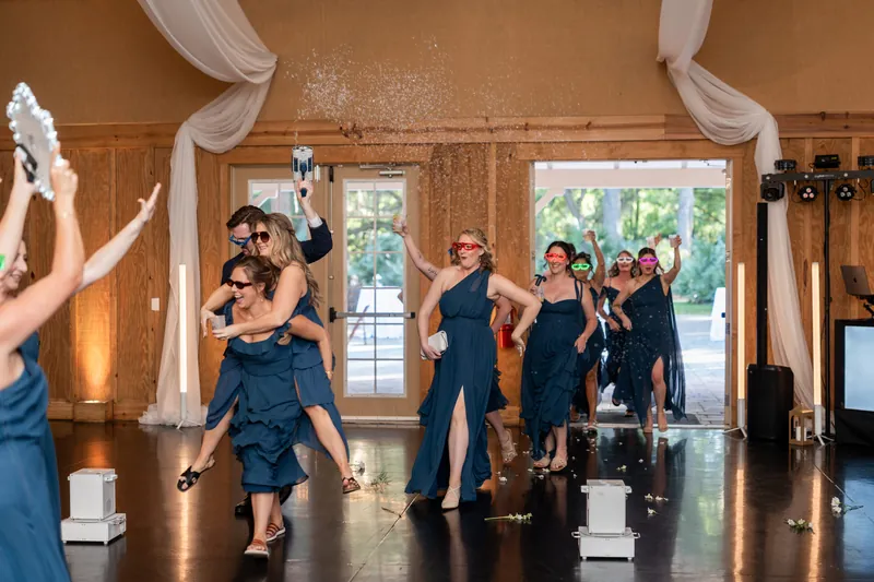 Bridal party grand entrance with confetti at Bowing Oaks indoor reception hall, Jacksonville FL