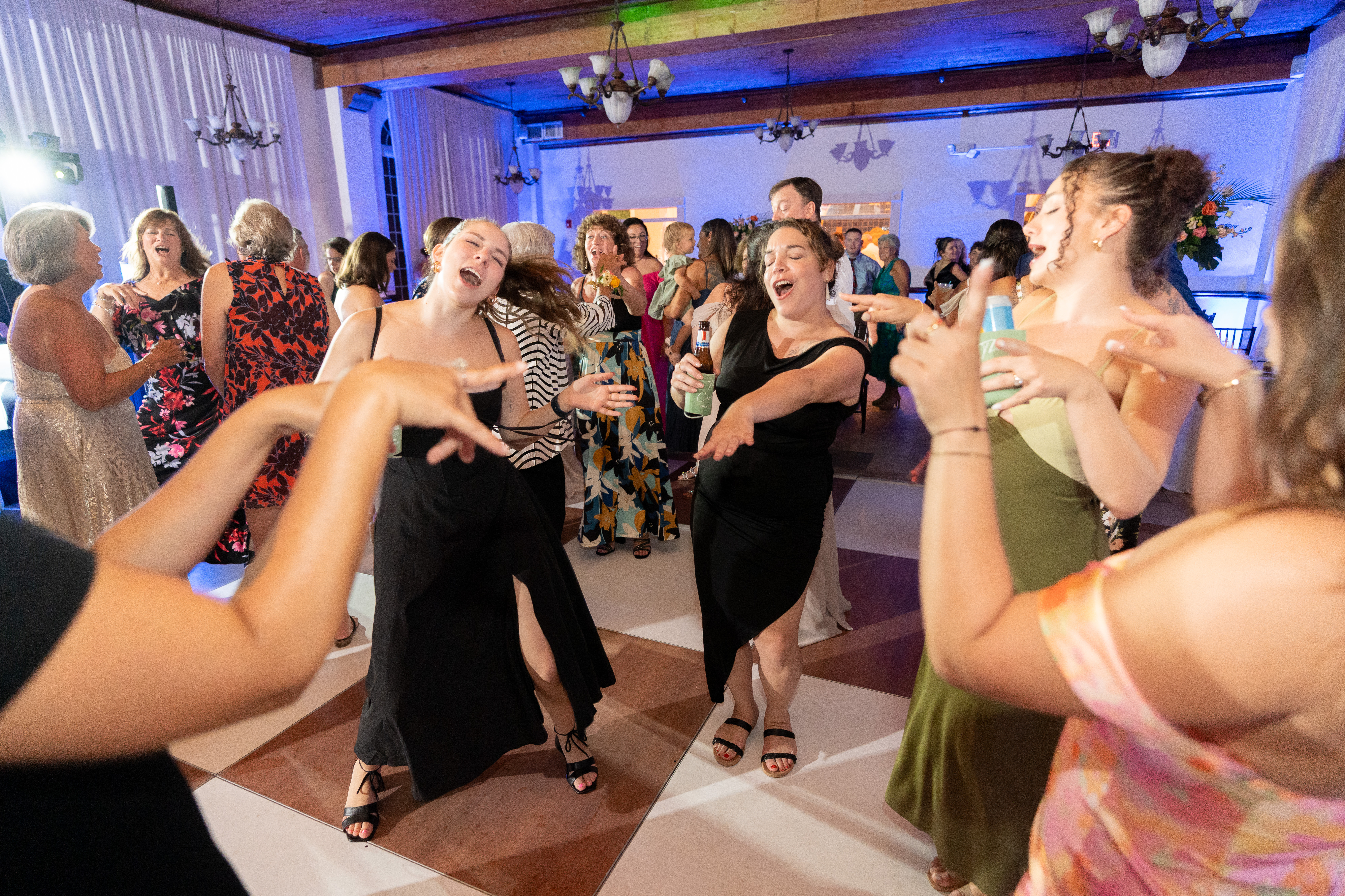 Packed dance floor at Casa Marina Hotel wedding reception with blue uplighting, Jacksonville Beach FL