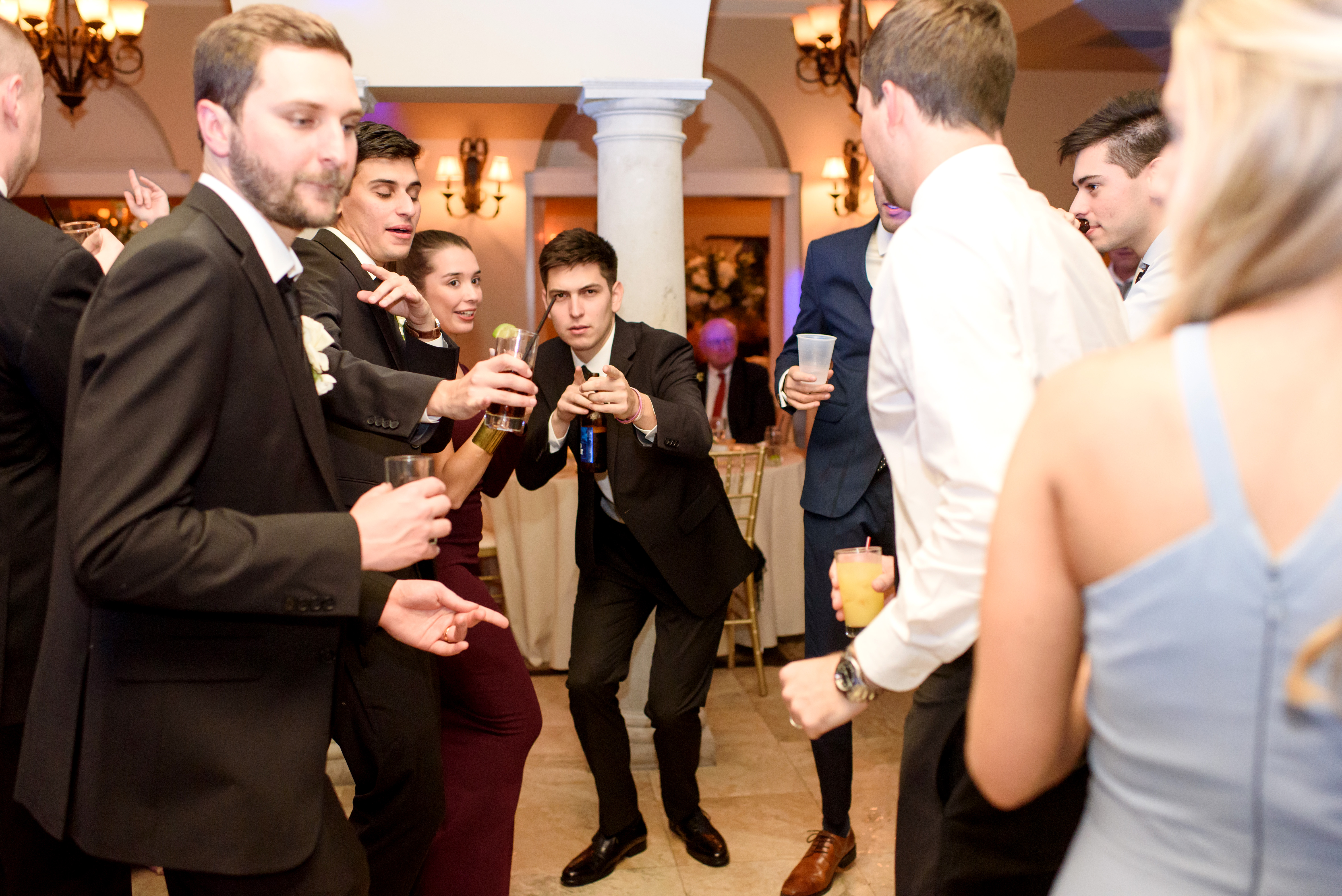 Wedding guests celebrating on the dance floor inside Club Continental Orange Park FL with arched columns in the background — Footloose Entertainment wedding DJ