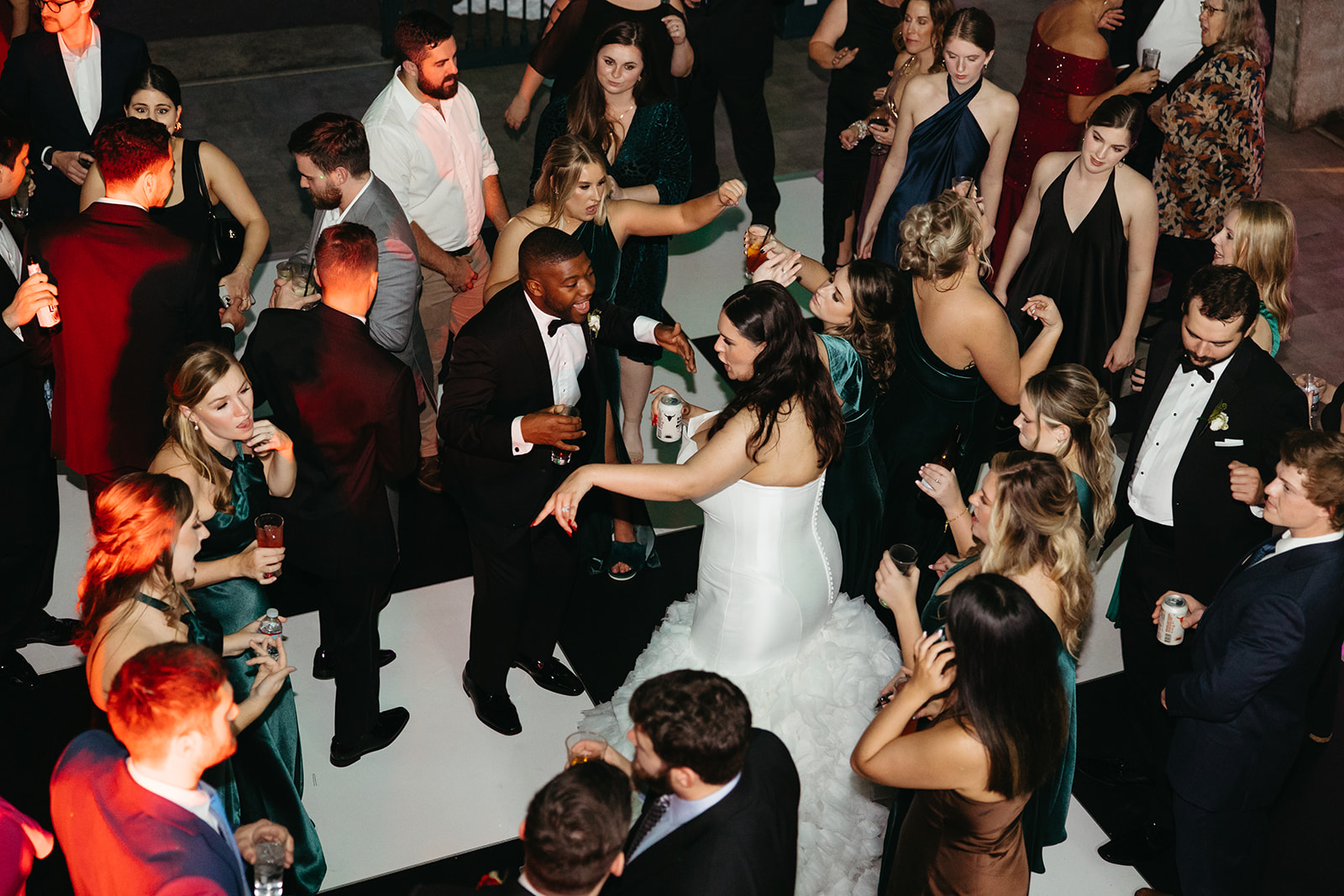 Wedding guests packed on the dance floor at the Lightner Museum St. Augustine FL — aerial view of bride dancing with guests during reception — Footloose Entertainment wedding DJ