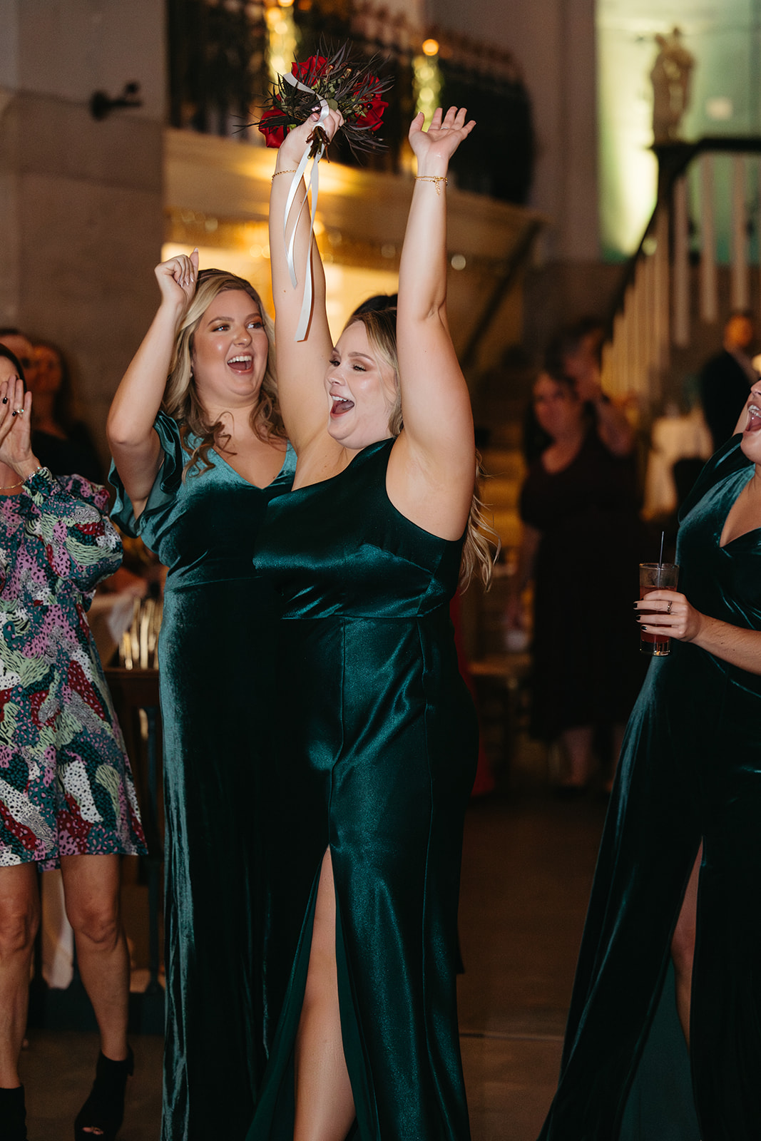 Bridesmaids celebrating at the Lightner Museum St. Augustine FL with bouquet toss, uplighting visible in background — Footloose Entertainment wedding DJ