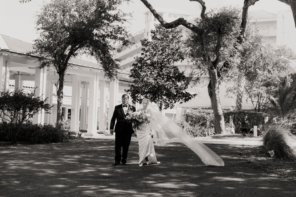 Bride and escort walking the grounds at Omni Amelia Island, Fernandina Beach FL
