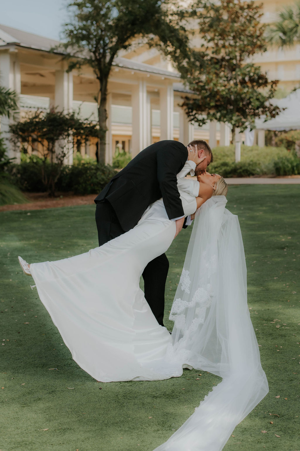 Couple sharing a dip kiss on the lawn at Omni Amelia Island resort, Fernandina Beach FL