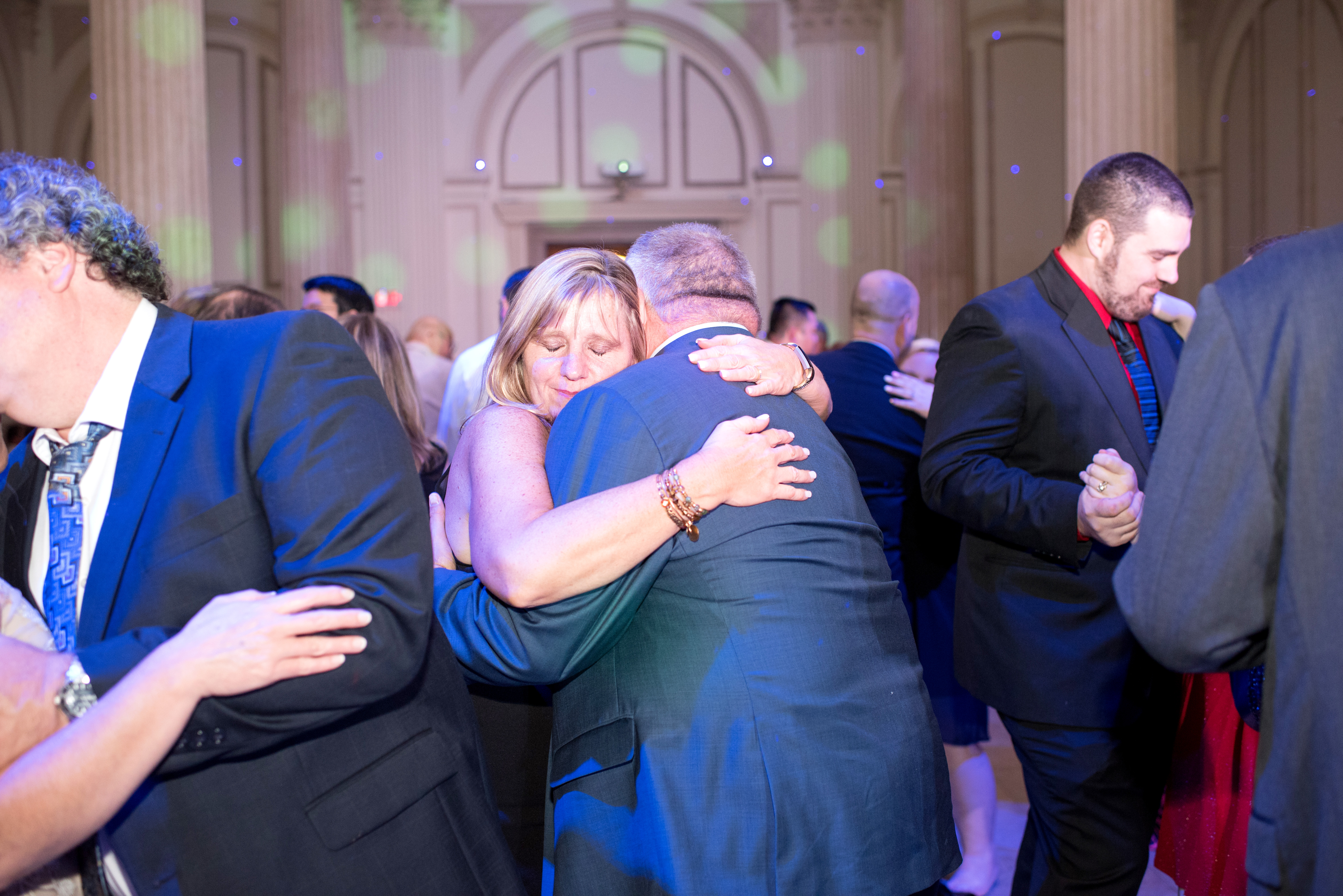 Couples slow dancing with blue uplighting at Treasury on the Plaza St Augustine FL — Footloose Entertainment wedding DJ