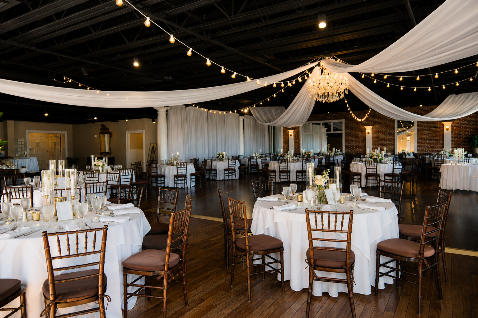 Wedding reception Grand Ballroom at The White Room St Augustine FL with string lights and white draping — Footloose Entertainment
