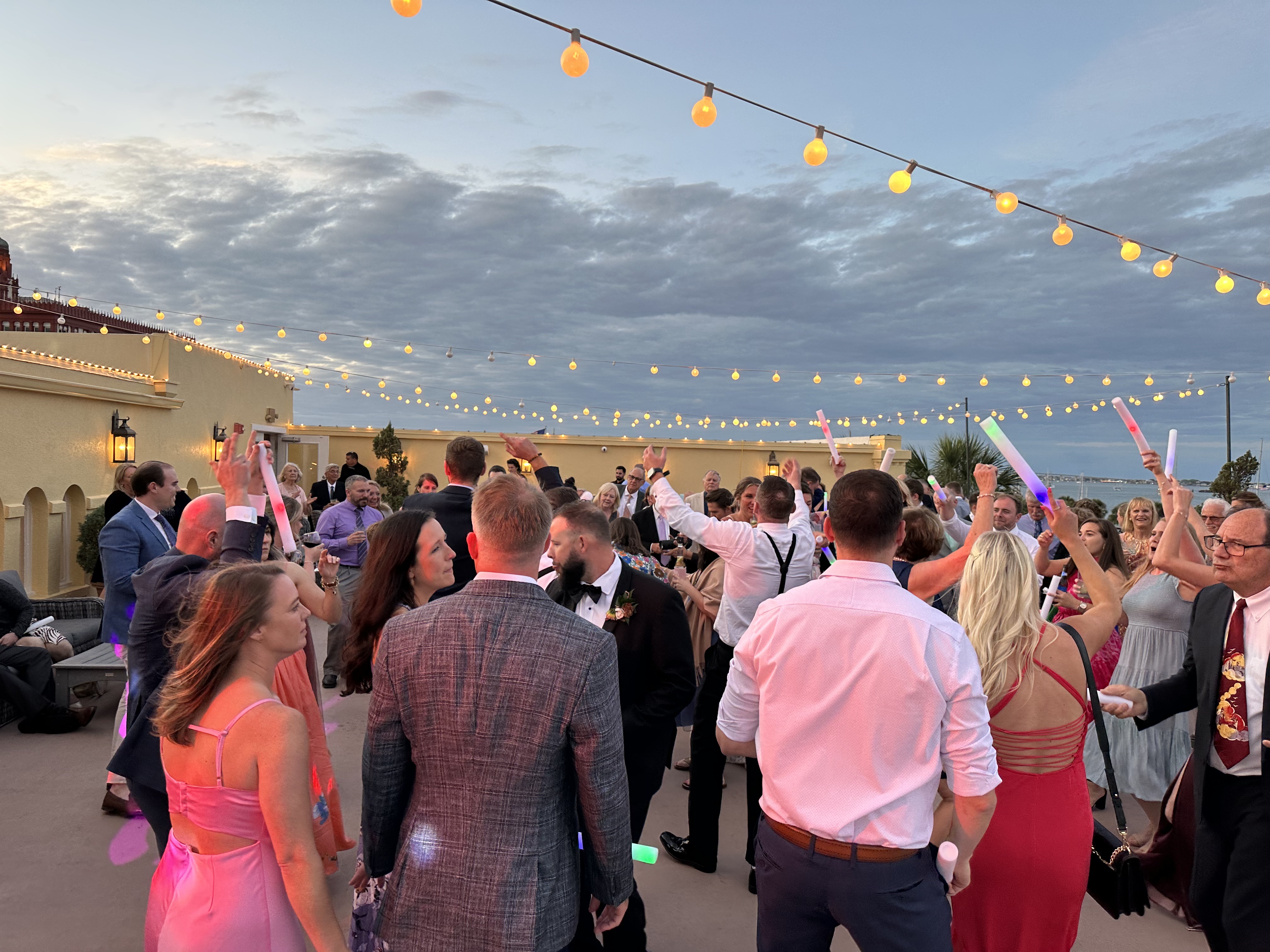 Wedding guests dancing on the rooftop at The White Room St Augustine FL with Matanzas Bay views — Footloose Entertainment DJ